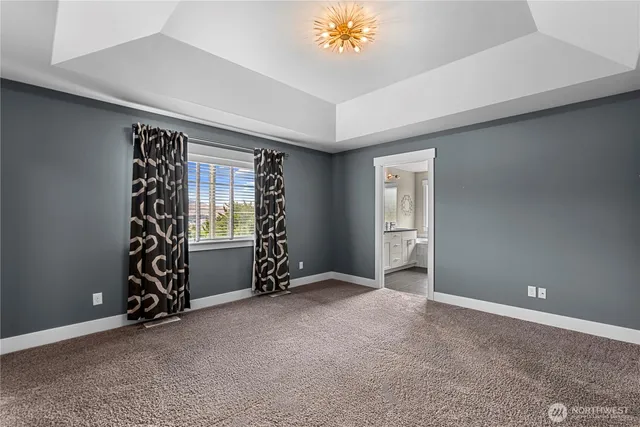 a view of a hallway with wooden floor and entryway