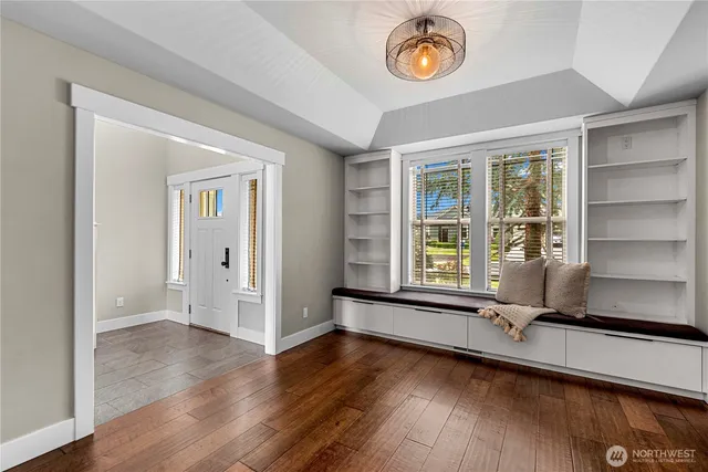a living room with fireplace furniture and a wooden floor