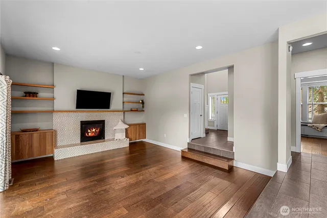 a living room with furniture fireplace and flat screen tv