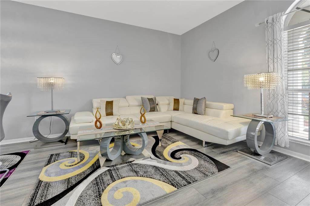 12847 Solola Way Trinity, FL 34655 - Photo 20 of 39 a living room with furniture and a wooden floor