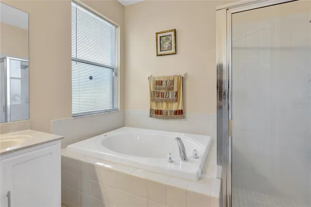 a white bath tub sitting next to a white sink