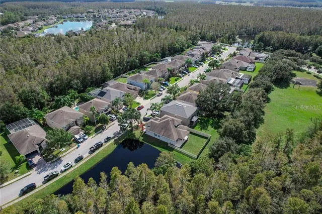 an aerial view of a house with a yard