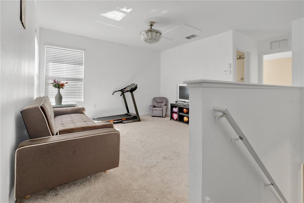 12847 Solola Way Trinity, FL 34655 - Photo 37 of 39 a living room with furniture and a flat screen tv