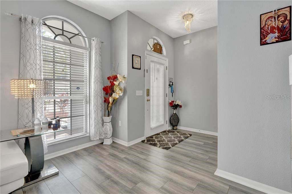 12847 Solola Way Trinity, FL 34655 - Photo 7 of 39 a living room with furniture and a window