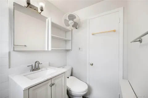 a white toilet sitting next to a bathroom sink