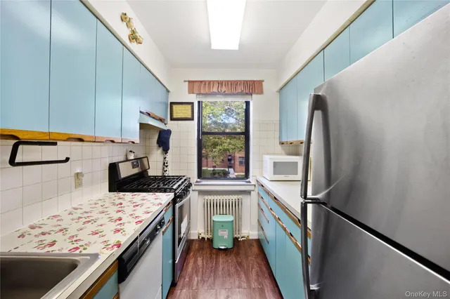 a kitchen with stainless steel appliances granite countertop a refrigerator a stove and a refrigerator