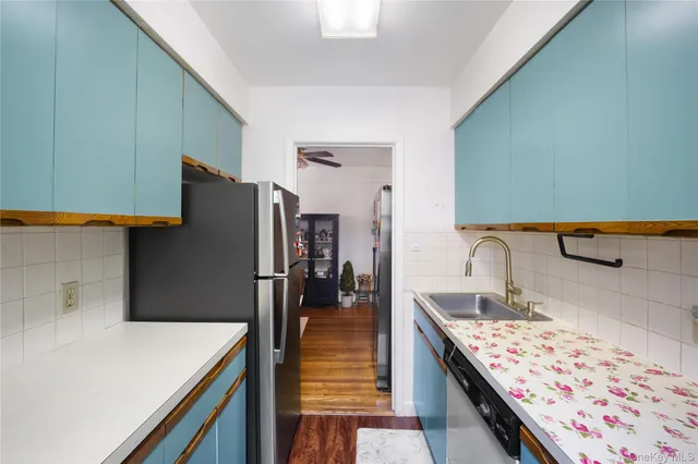 a kitchen with a refrigerator and a sink