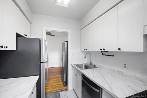 a kitchen with stainless steel appliances a sink and a refrigerator
