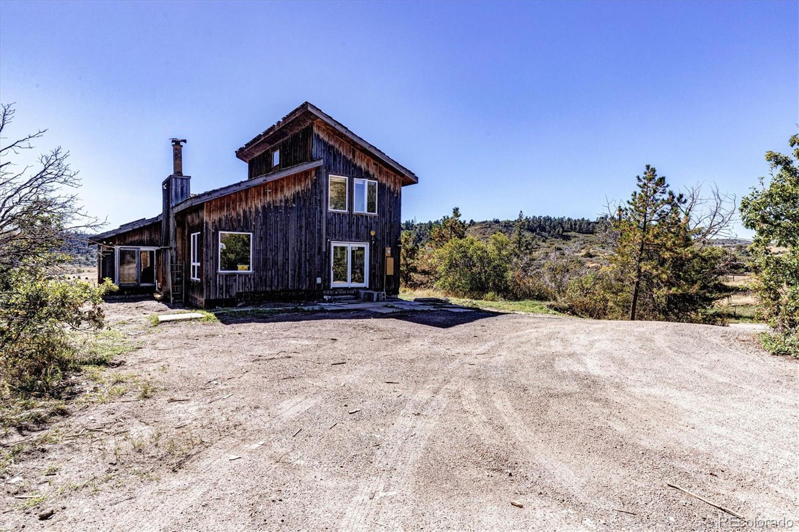 86 Highway 86 Franktown, CO 80116 - Photo 5 of 30 a front view of a house with a yard