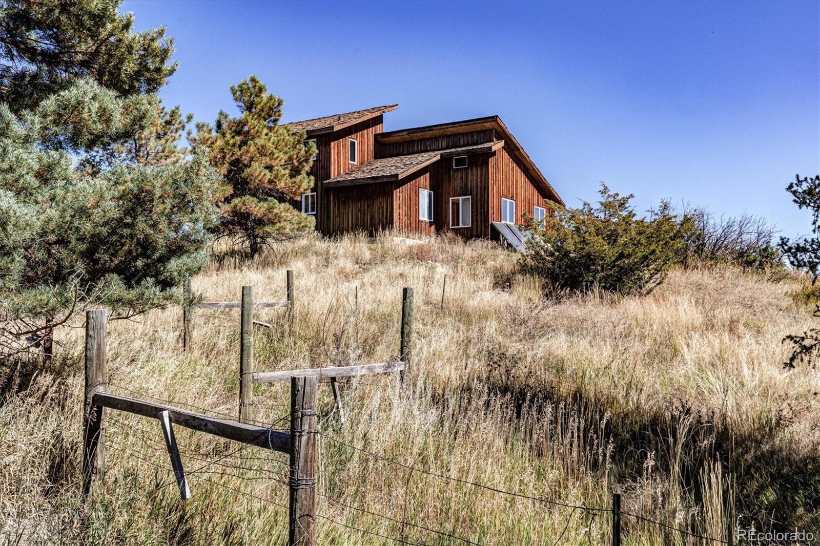 86 Highway 86 Franktown, CO 80116 - Photo 9 of 30 a view of a house with a yard
