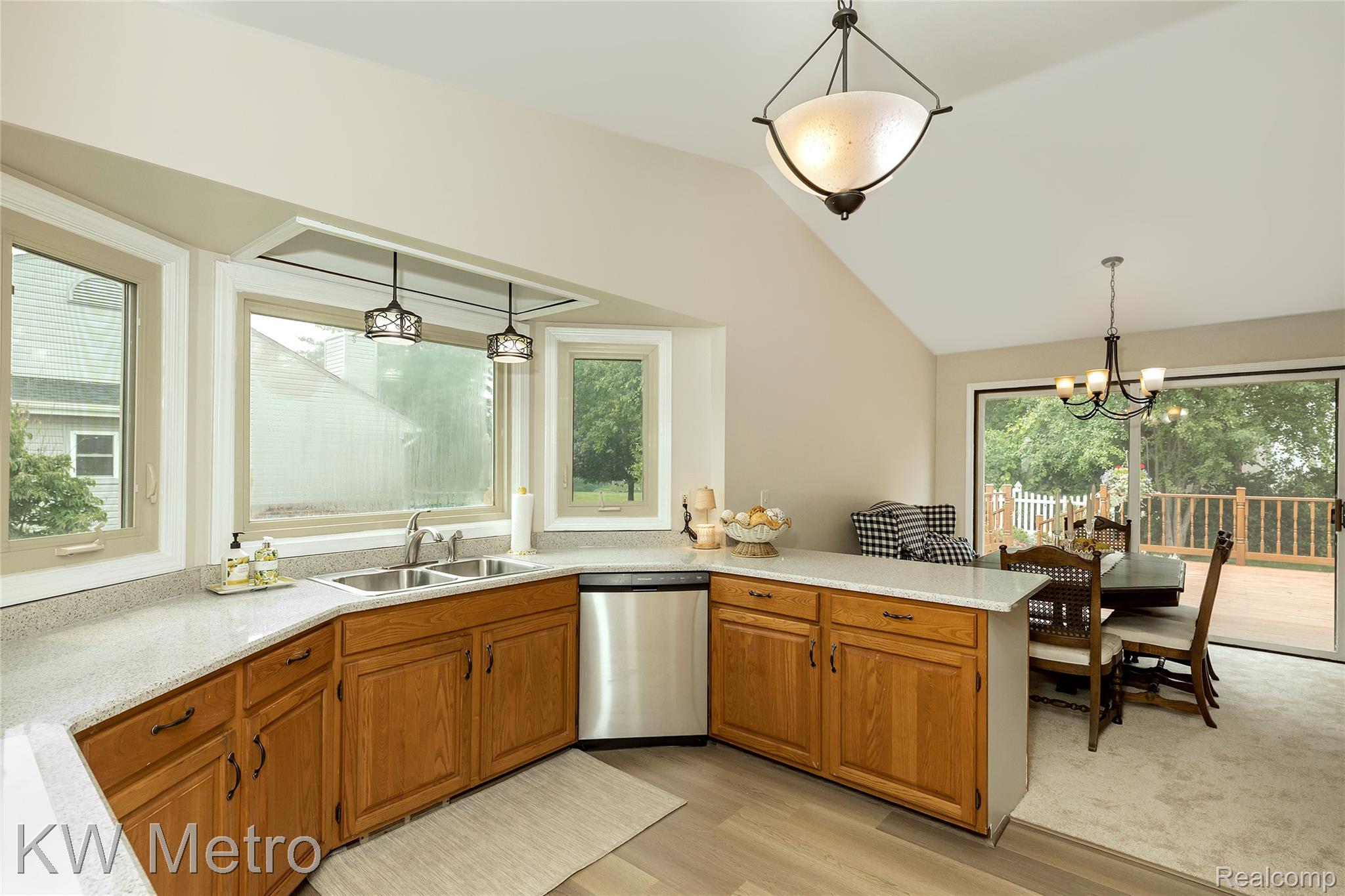 2154 Warrington Road Rochester, MI 48307 - Photo 18 of 41 Kitchen featuring wood cabinetry, light-toned countertops, and a double basin stainless steel sink