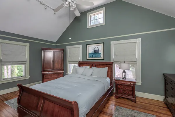a bedroom with a large bed and a window