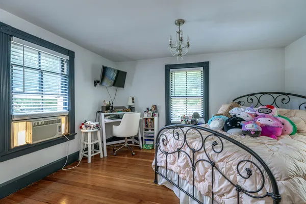 a bedroom with furniture and a window