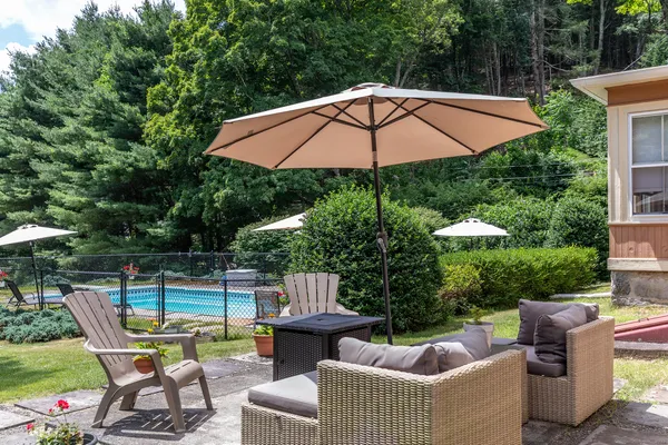 a view of a patio with couches under an umbrella
