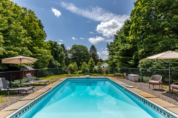 a view of a swimming pool and lounge chairs
