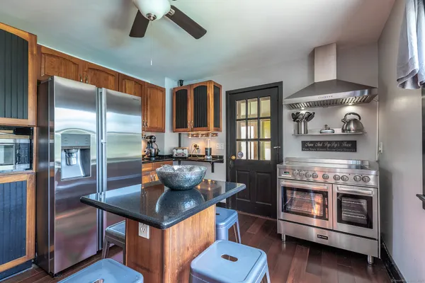 a kitchen with stove and cabinets