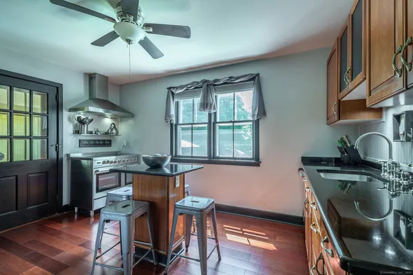 a dining room with furniture a window and wooden floor
