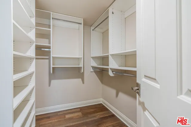 a view of walk in closet with empty racks