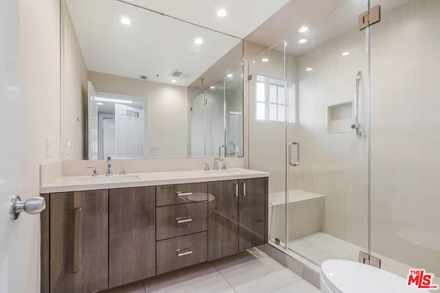 a spacious bathroom with a double vanity sink mirror double and shower
