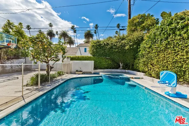 a swimming pool with outdoor seating and yard