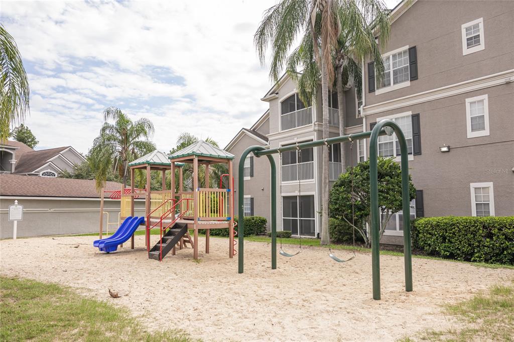 3391 South Kirkman Road, Unit 1216 Orlando, FL 32811 - Photo 32 of 33 a view of a house with backyard and a slide