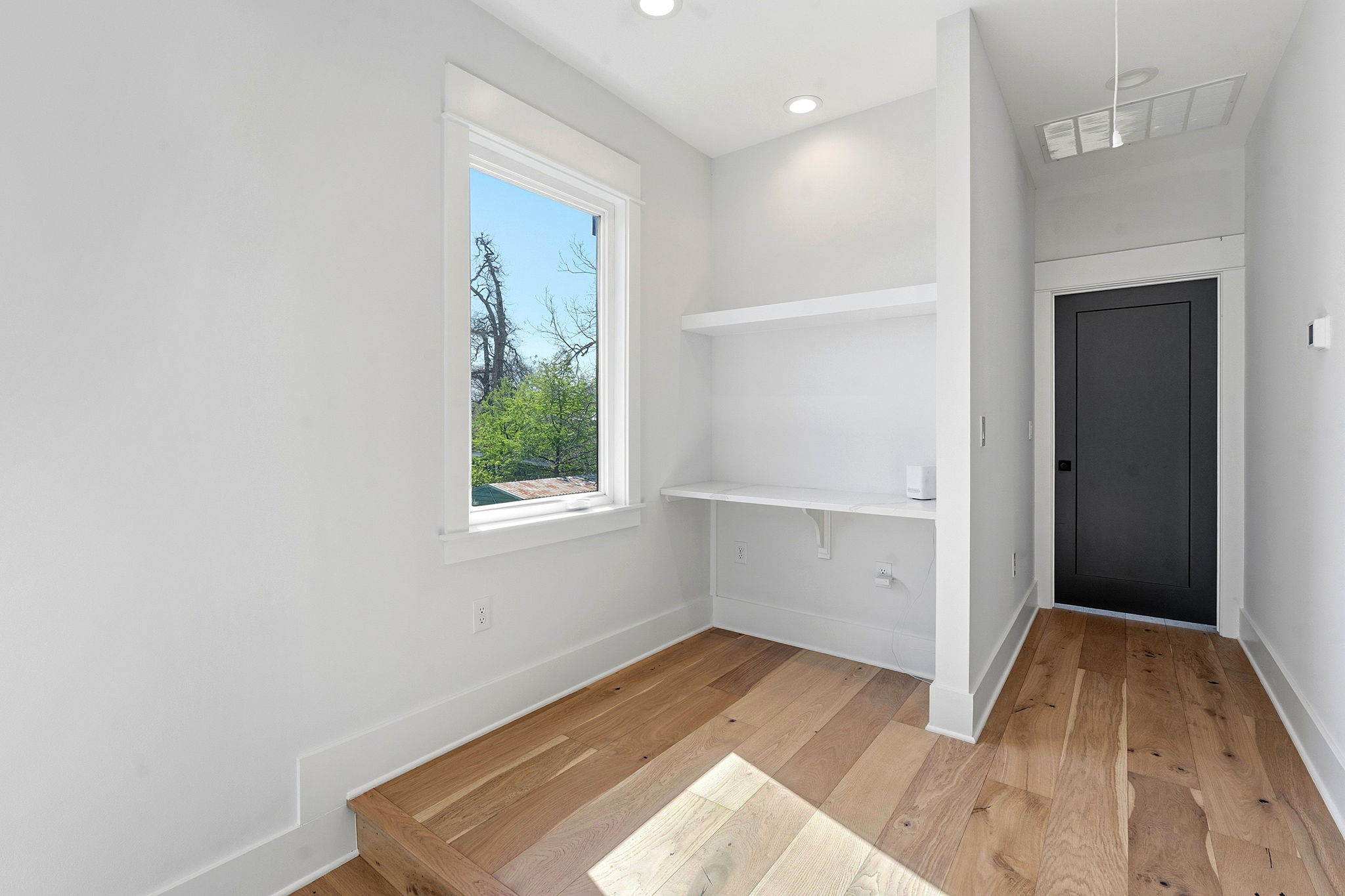 2921 Lyons Road, Unit 1 Austin, TX 78702 - Photo 12 of 20 a view of a bedroom with wooden floor and front door