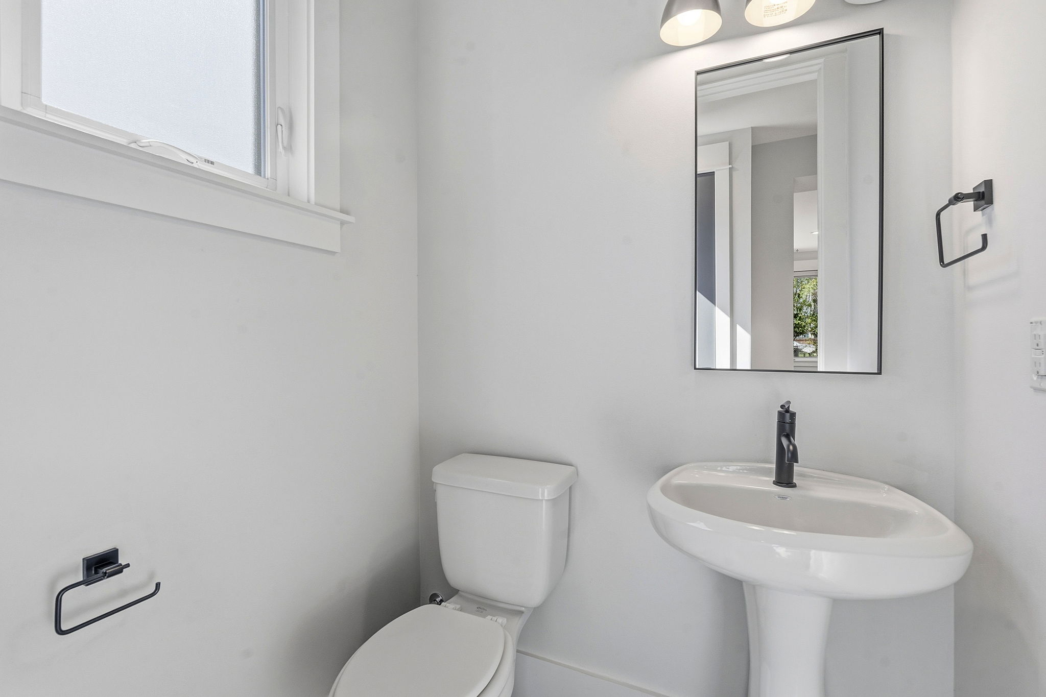 2921 Lyons Road, Unit 1 Austin, TX 78702 - Photo 16 of 20 a bathroom with a toilet sink and mirror