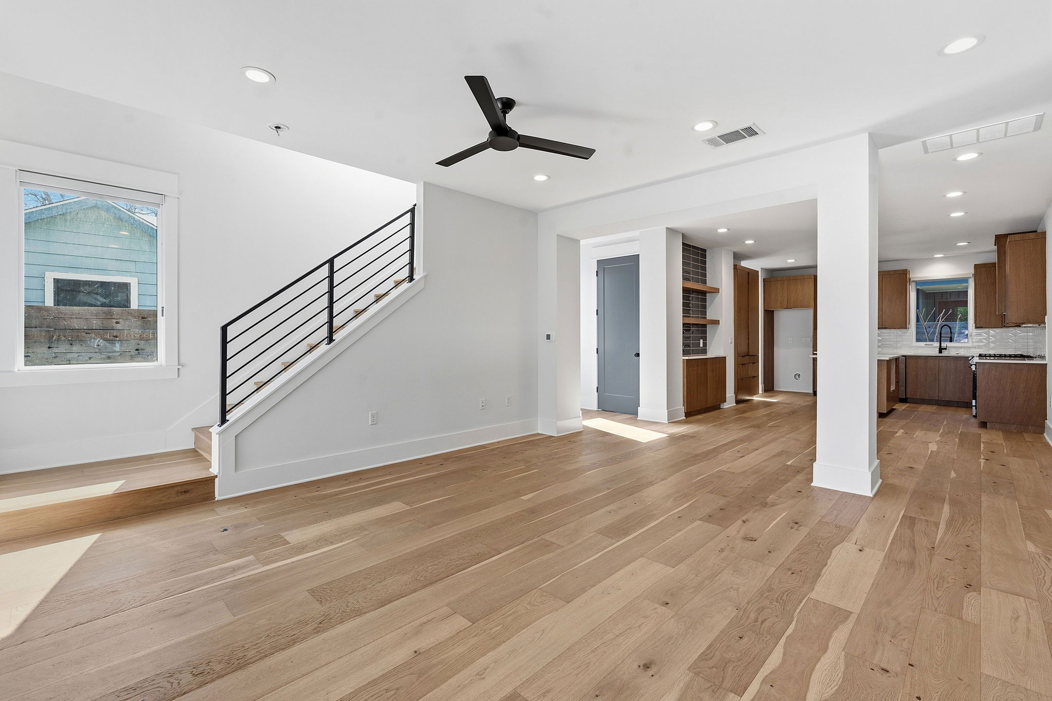 2921 Lyons Road, Unit 1 Austin, TX 78702 - Photo 3 of 20 a view of an empty room with wooden floor and a ceiling fan