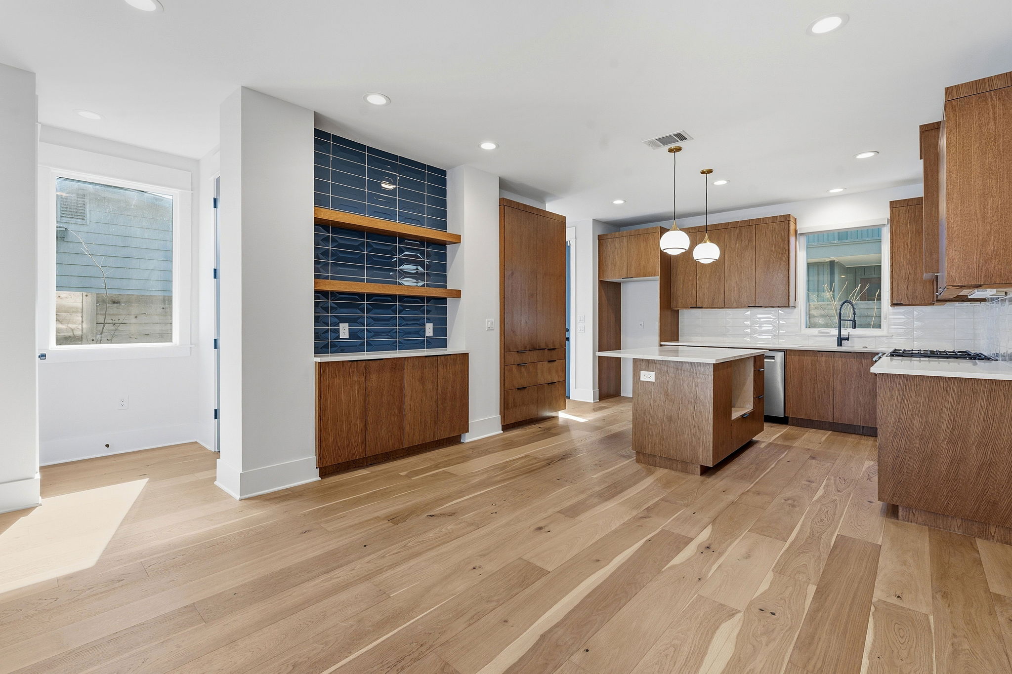 2921 Lyons Road, Unit 1 Austin, TX 78702 - Photo 4 of 20 a large kitchen with stainless steel appliances kitchen island granite countertop a refrigerator and a stove top oven
