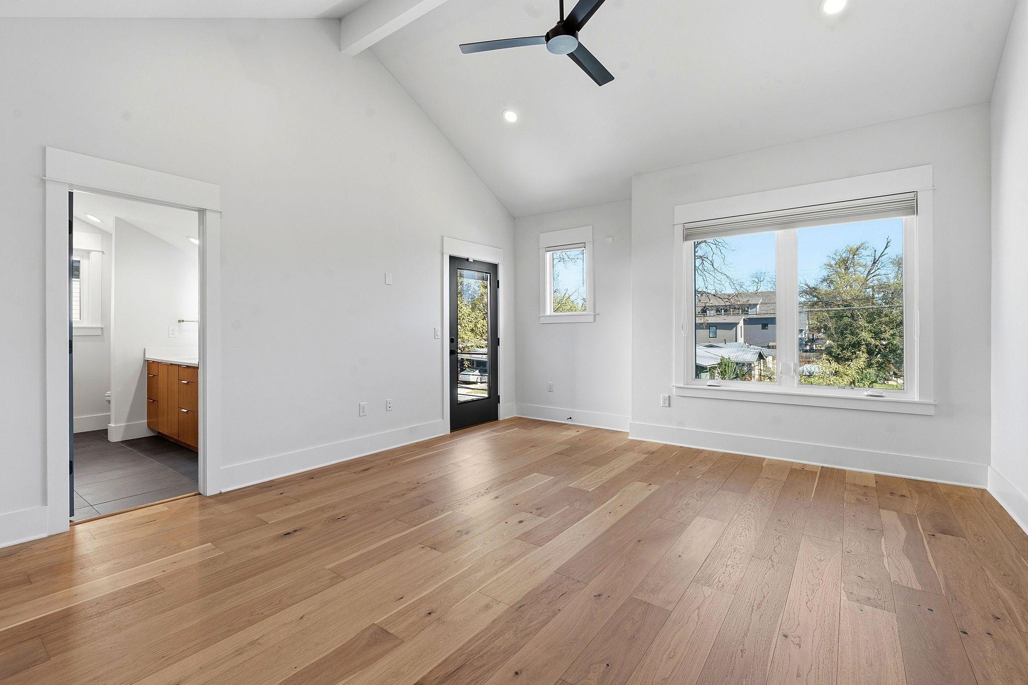 2921 Lyons Road, Unit 1 Austin, TX 78702 - Photo 9 of 20 wooden floor in an empty room with a window