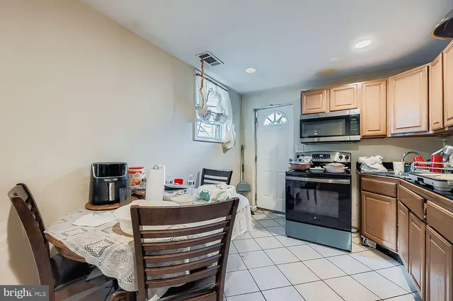 a kitchen with a stove a sink and a refrigerator