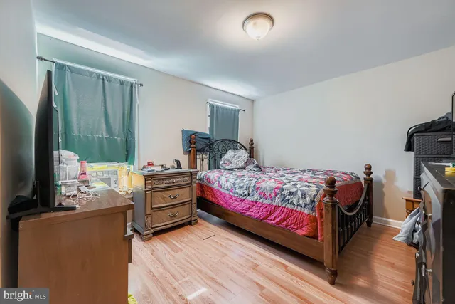 a bedroom with a bed and a flat tv screen