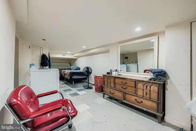 a room with furniture a flat screen tv and a dresser