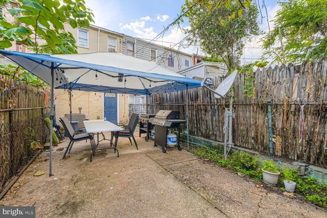a view of a chairs and table in the backyard