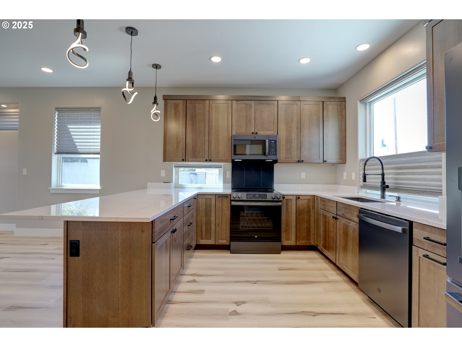 211 Heisler Street Dufur, OR 97021 - Photo 11 of 26 a kitchen with kitchen island granite countertop a stove top oven sink and cabinets