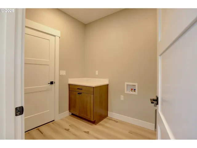 a view of an empty room and wooden floor