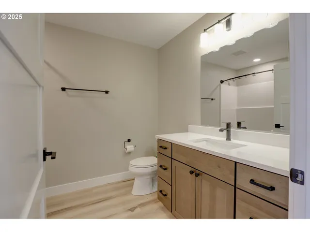 a bathroom with a sink toilet and mirror