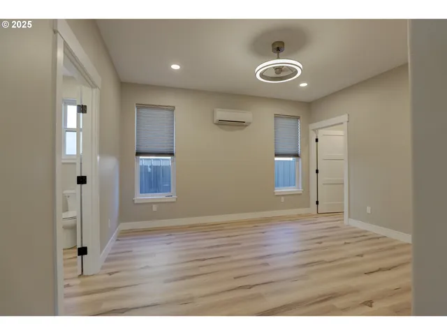 a view of an empty room and wooden floor