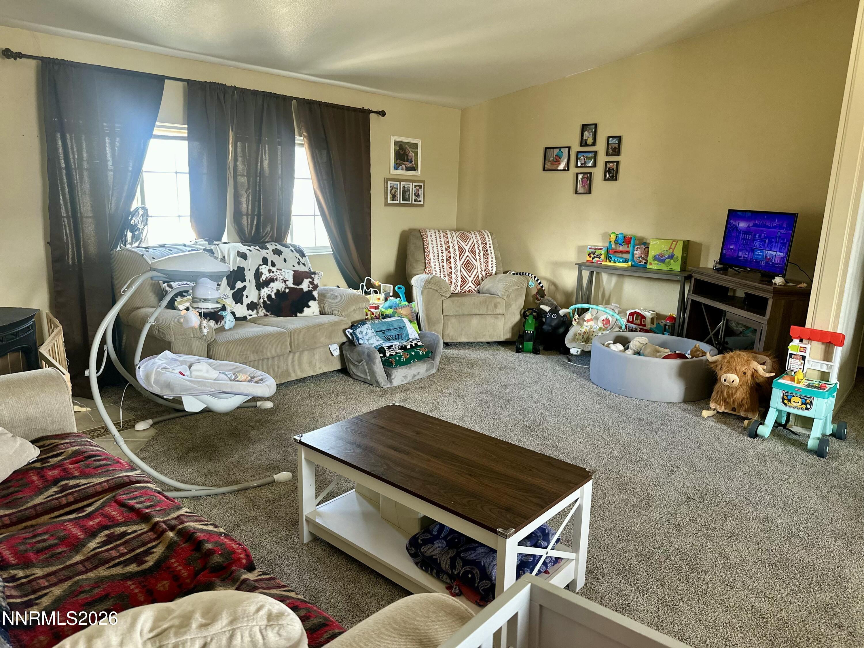 153 Territory Road Dayton, NV 89403 - Photo 11 of 23 a living room with furniture and a flat screen tv