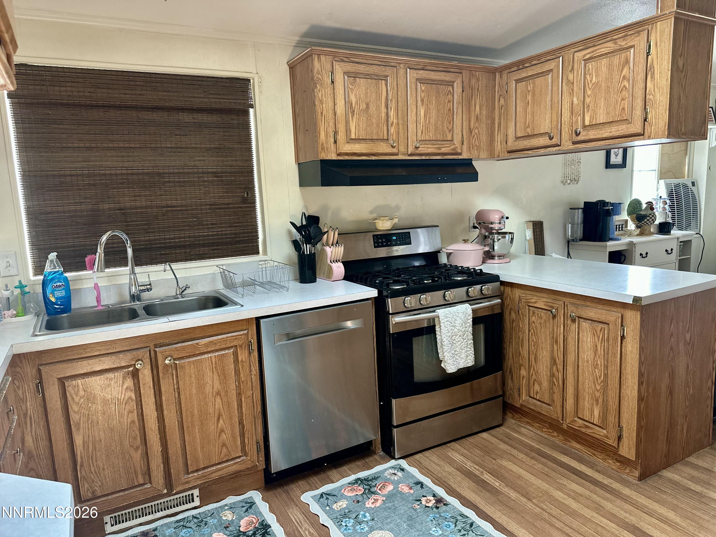 153 Territory Road Dayton, NV 89403 - Photo 13 of 23 a kitchen with granite countertop a sink stove and cabinets
