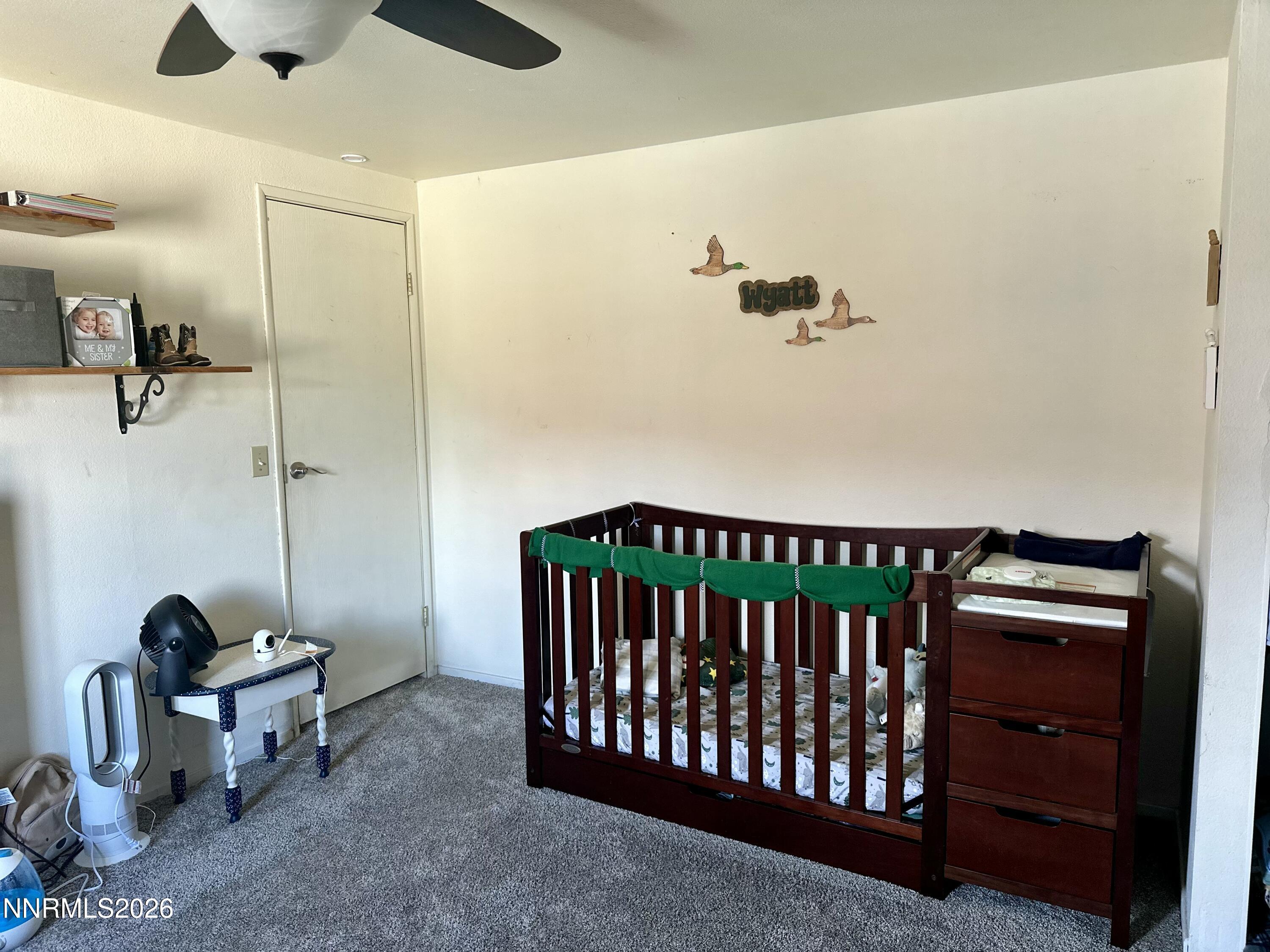 153 Territory Road Dayton, NV 89403 - Photo 19 of 23 a bedroom with a bed and a chandelier