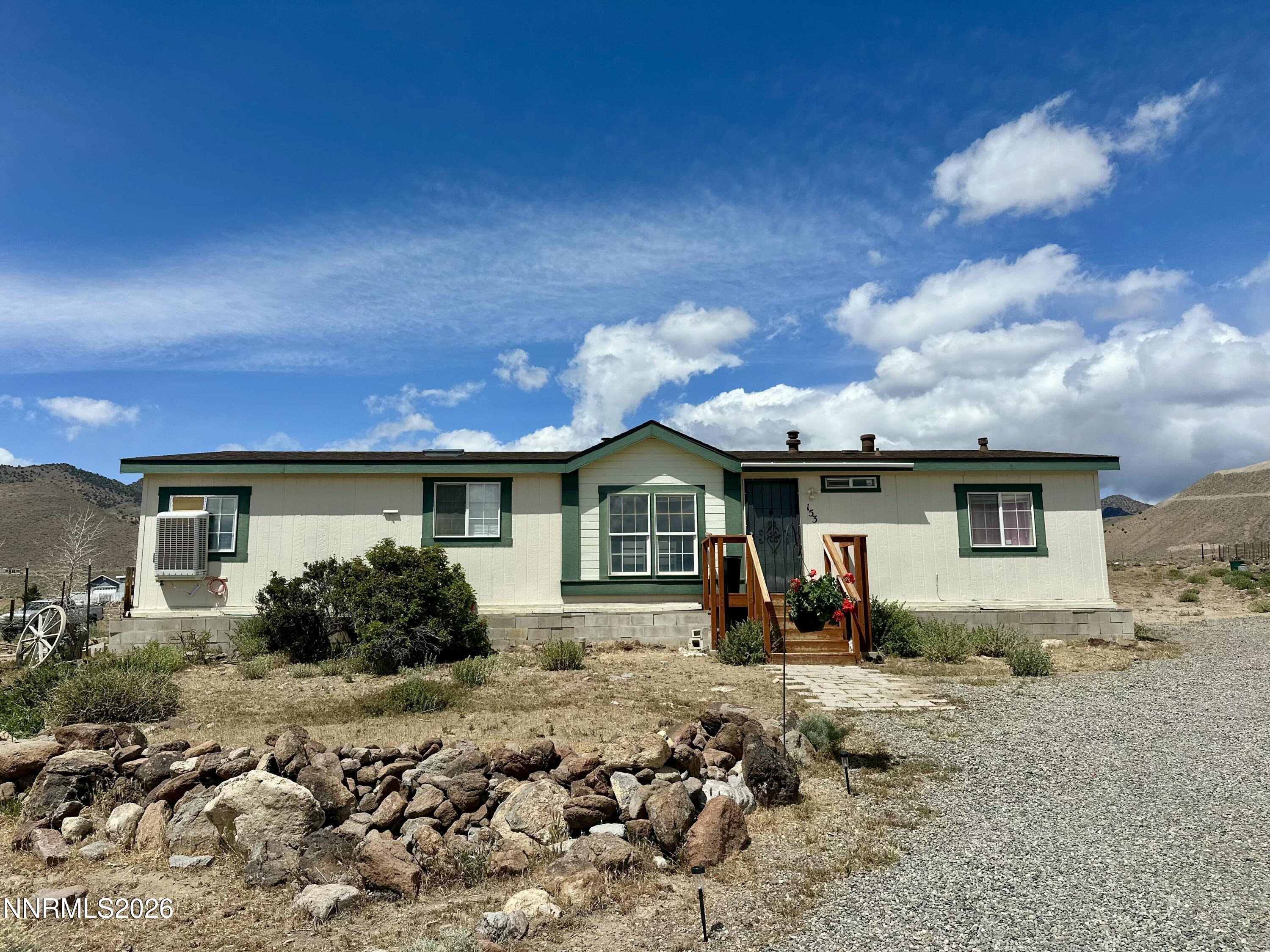 153 Territory Road Dayton, NV 89403 - Photo 2 of 23 a front view of a house with garden