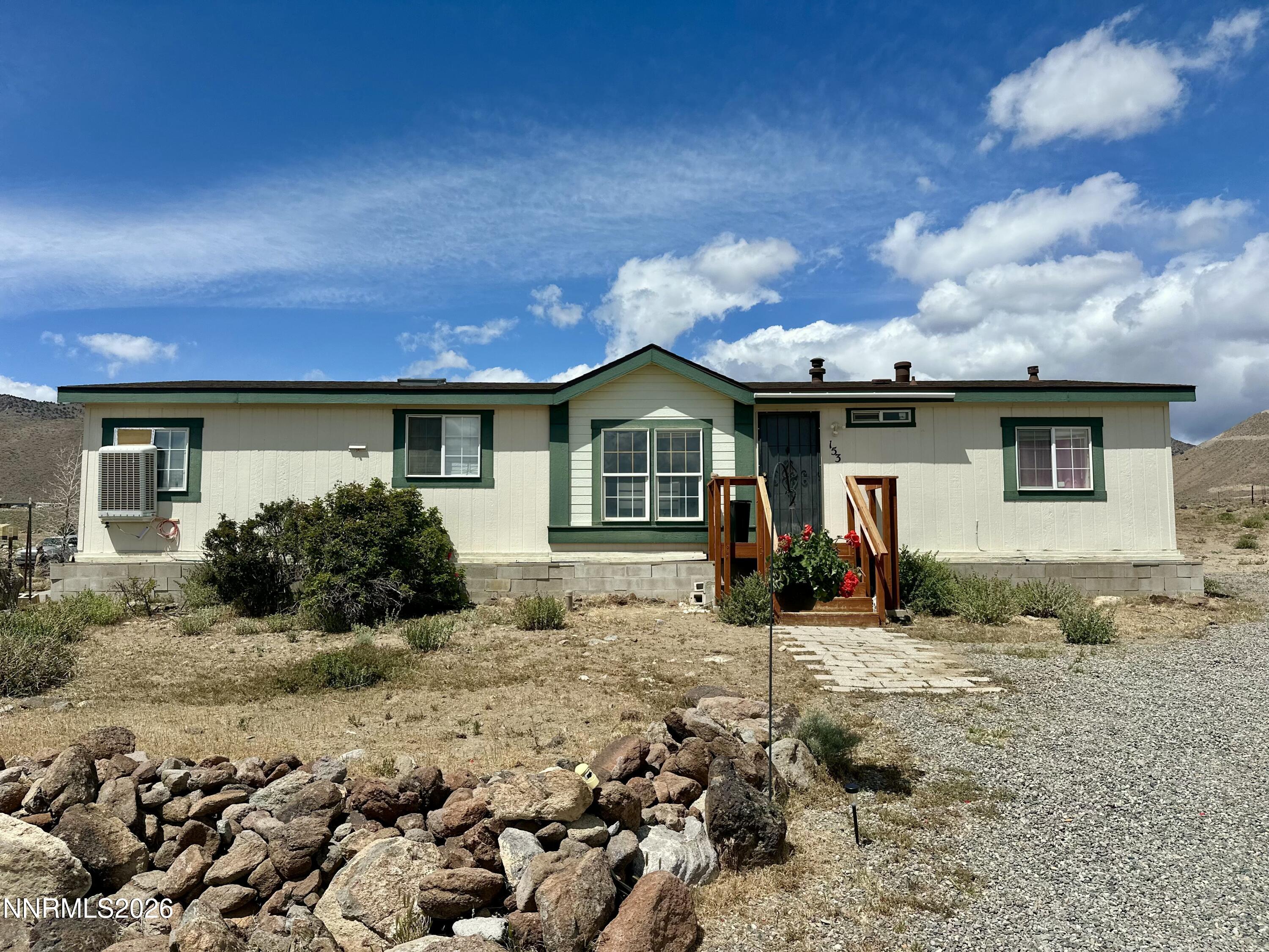 153 Territory Road Dayton, NV 89403 - Photo 3 of 23 a front view of a house with a yard