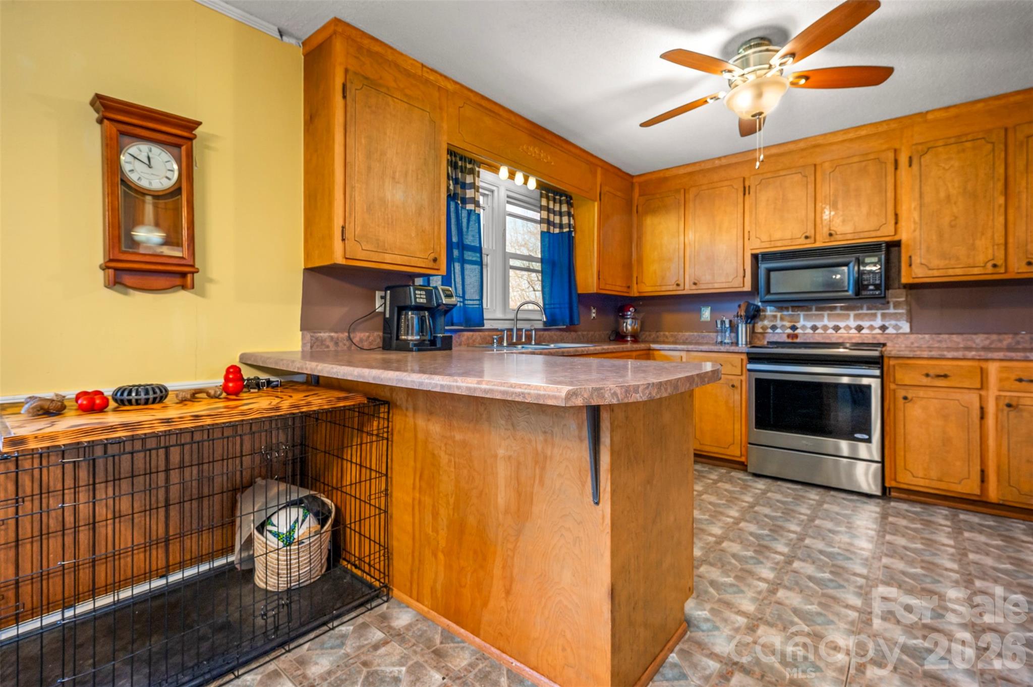 414 Sandy Run Church Road Mooresboro, NC 28114 - Photo 13 of 38 a kitchen with stainless steel appliances granite countertop a stove a sink and a refrigerator
