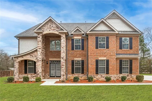 a view of a hallway with wooden floor windows and a living room
