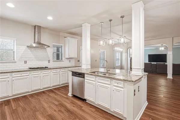 a view of a kitchen with wooden floor and a kitchen
