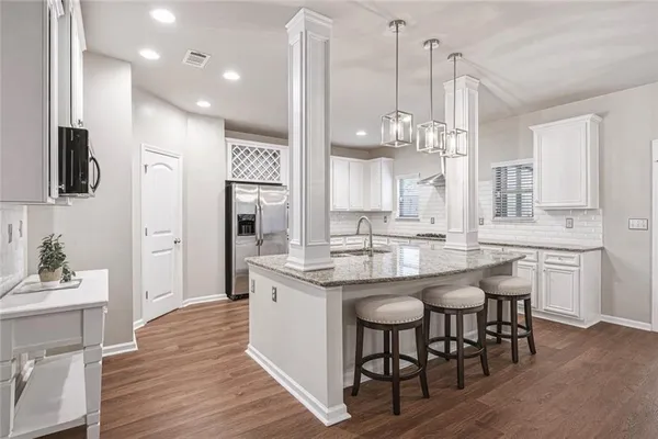a view of a hallway with wooden floor and entryway