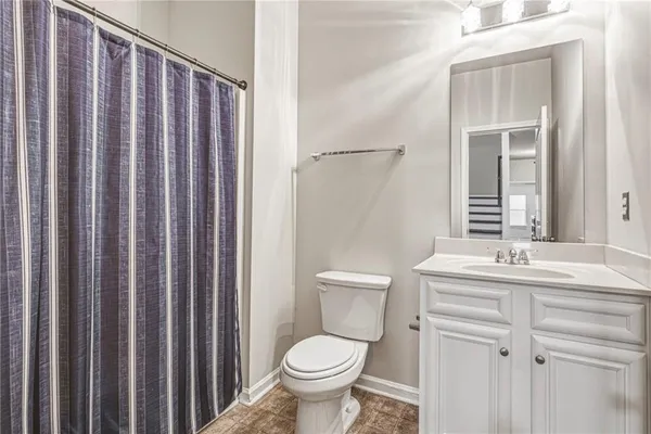 a spacious bedroom with a bed and a chandelier
