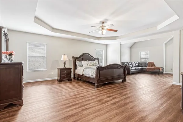 a living room with furniture and a hard wood floor