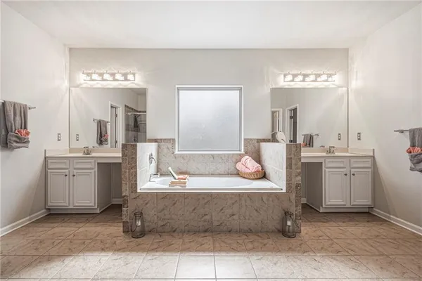 a spacious bedroom with a bed and cabinets